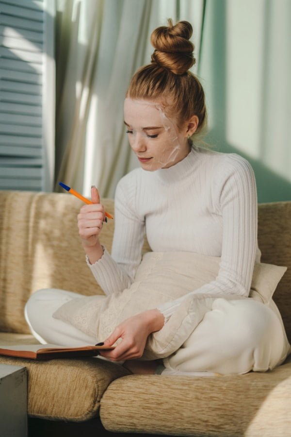 Harnessing the Power of Journaling for Personal Growth: A Comprehensive Guide 10 young woman writing her journal while doing her face mask for selfcare- Benefits of Journaling for Personal Growth