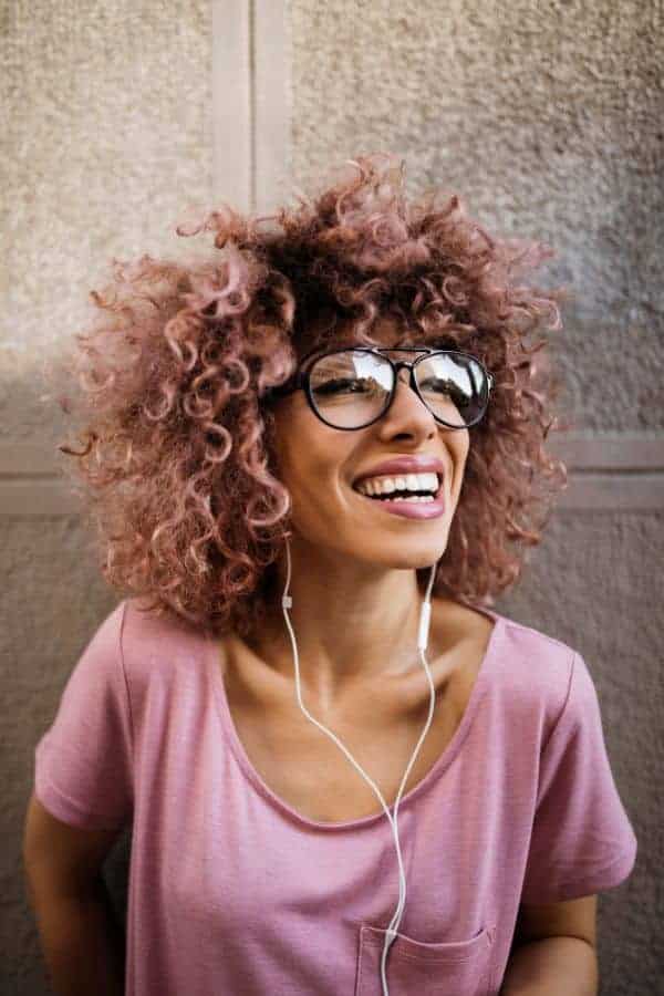 How to Set Personal Boundaries and Say No for Improved Mental Health 4 woman in a pink shirt, pink hair with big smile.
