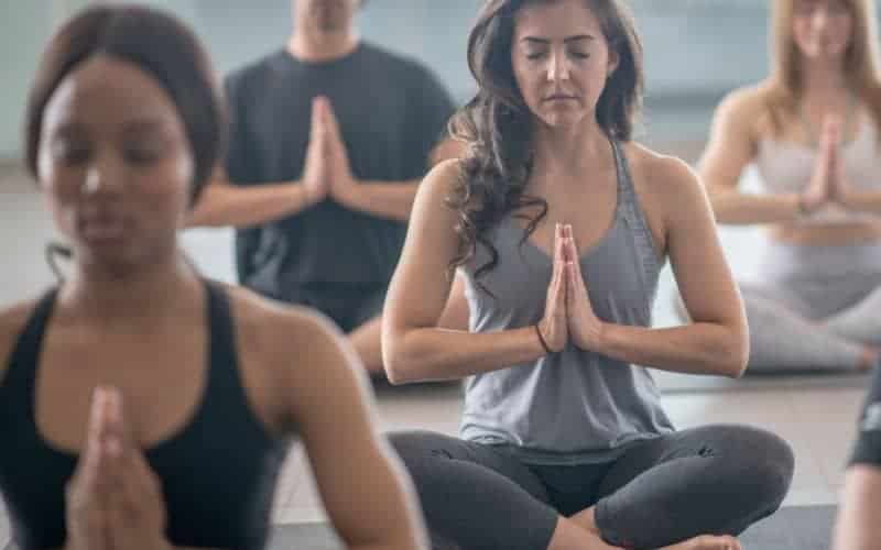 What Is Puppy Yoga? A Detailed Explanation 6 women in yoga class