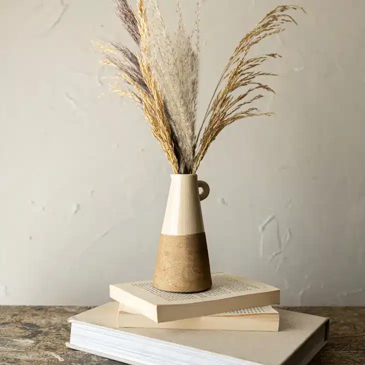 Best tips to Buying and Caring for Stoneware 3 small stoneware vase on a stack of books